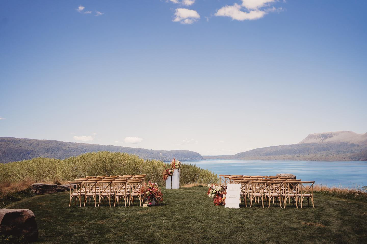 A lakeside wedding ceremony set up overlooking a lake in Rotorua